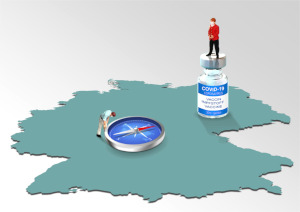 On a map of Germany, a miniature Angela Merkel is standing on a vaccination dose looking down on a miniature man who is looking at a large compass